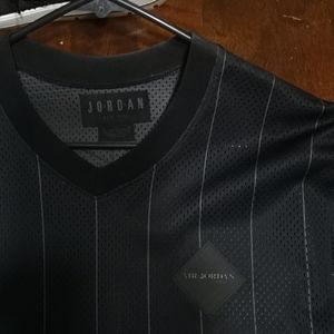 Men's all black pin stripe jersey size medium.